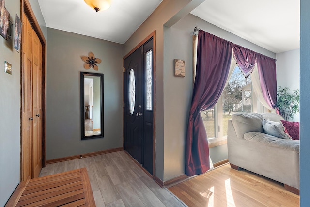 entryway featuring light wood finished floors and baseboards