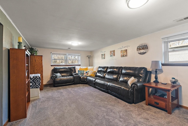 carpeted living room with a healthy amount of sunlight and visible vents