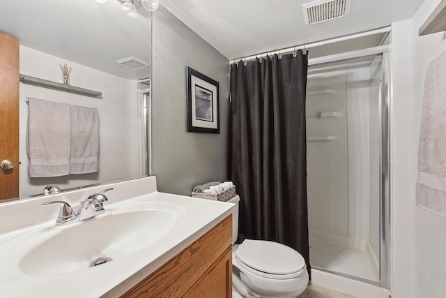 bathroom featuring visible vents, toilet, a stall shower, and vanity