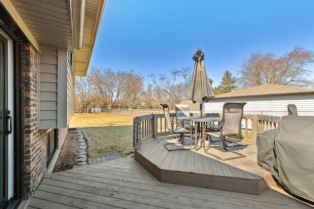 wooden terrace with grilling area and outdoor dining area