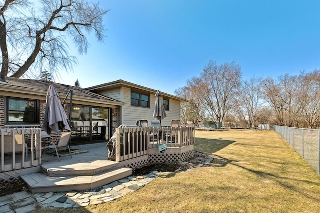 view of yard with a deck, outdoor dining space, and a fenced backyard