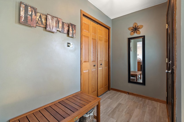 entryway featuring light wood-type flooring and baseboards