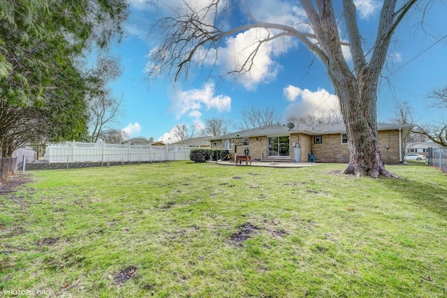 view of yard with a fenced backyard and a patio