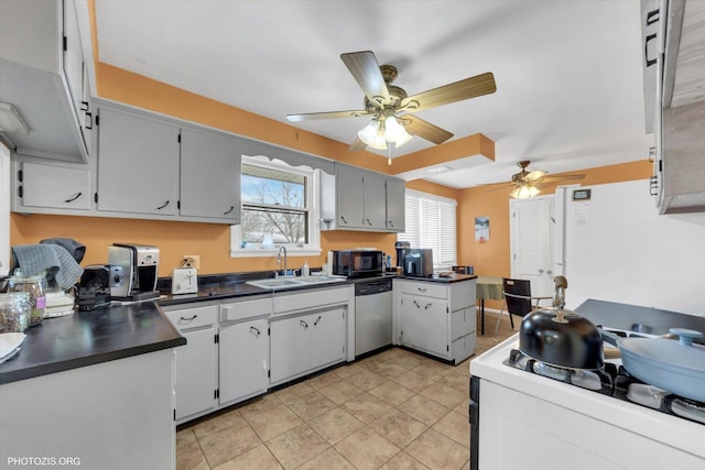 kitchen with a ceiling fan, a sink, dark countertops, white appliances, and light tile patterned floors