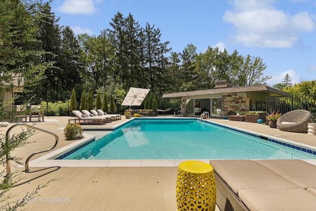 view of swimming pool with a fenced in pool, fence, a patio, and an outdoor living space