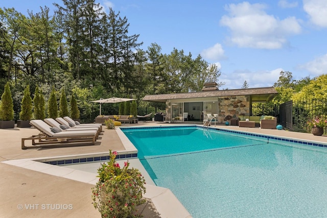 outdoor pool featuring a patio area and outdoor lounge area