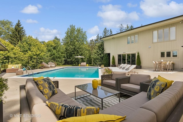 pool featuring an outdoor living space and a patio area