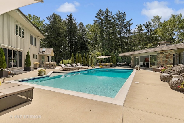 outdoor pool with a patio and an outdoor living space