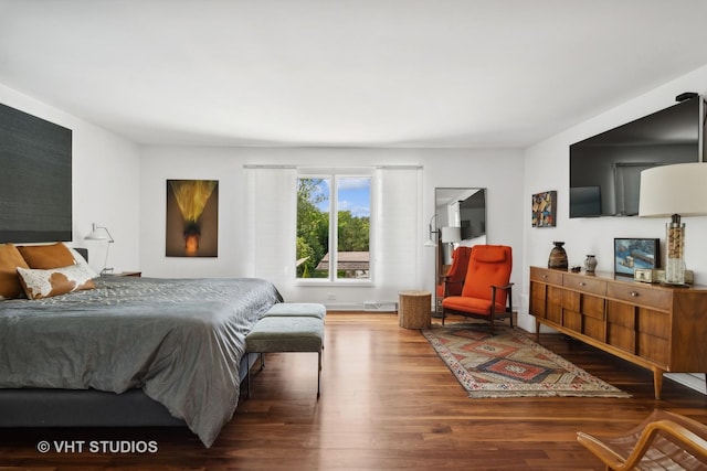 bedroom with visible vents and wood finished floors