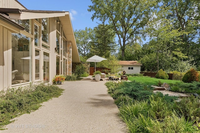 view of home's community with a patio and fence