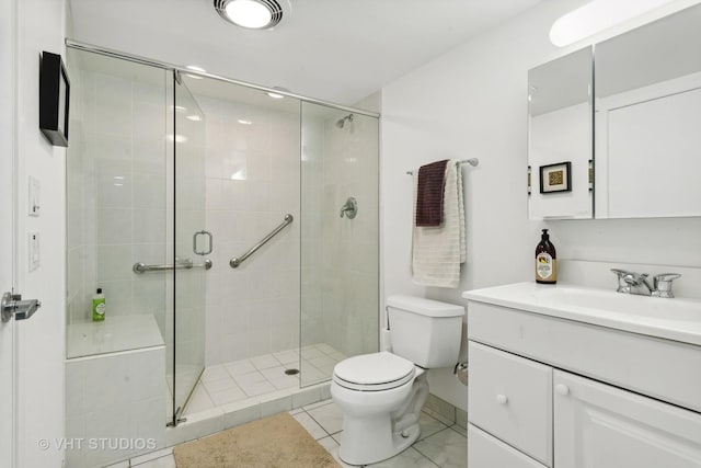 full bath with toilet, tile patterned floors, a shower stall, and vanity