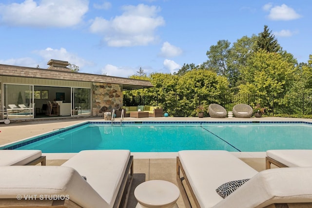 view of swimming pool featuring a patio, an outdoor living space, and a fenced in pool