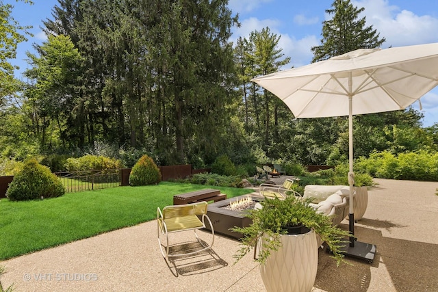 view of patio featuring fence and a fire pit