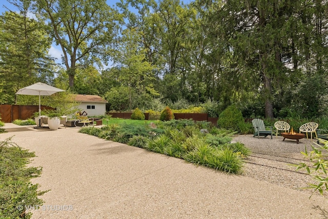 view of patio with an outdoor fire pit and fence