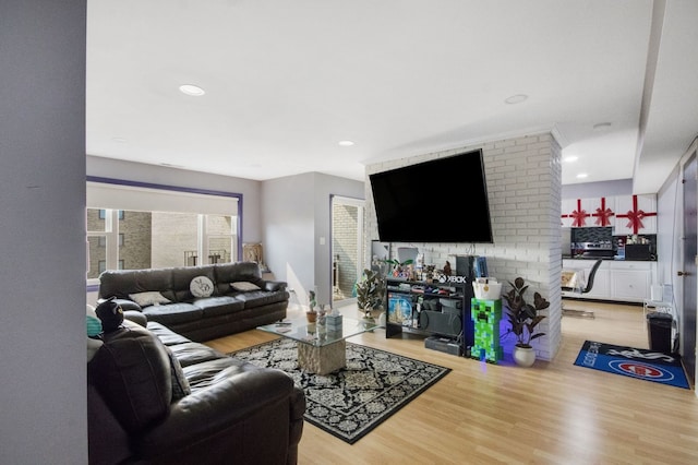 living room with light wood finished floors and recessed lighting