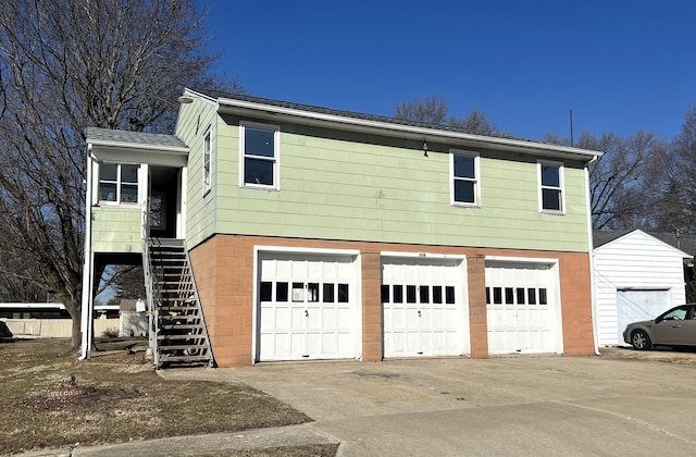 exterior space featuring stairway and an attached garage