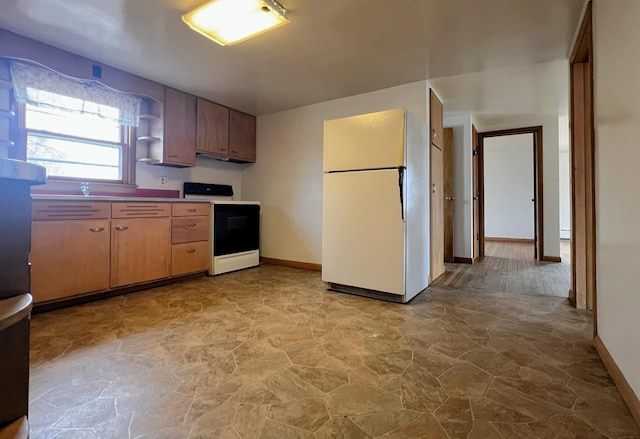 kitchen featuring electric range, open shelves, freestanding refrigerator, light countertops, and baseboards