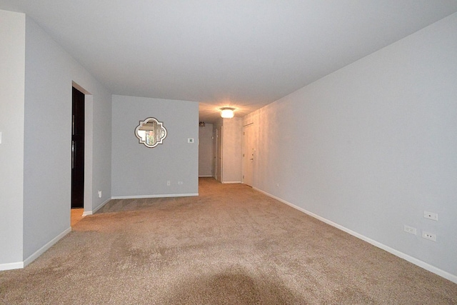 empty room with light carpet and baseboards