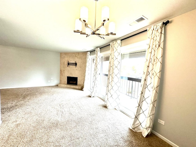 unfurnished living room featuring visible vents, carpet, a fireplace, baseboards, and a chandelier