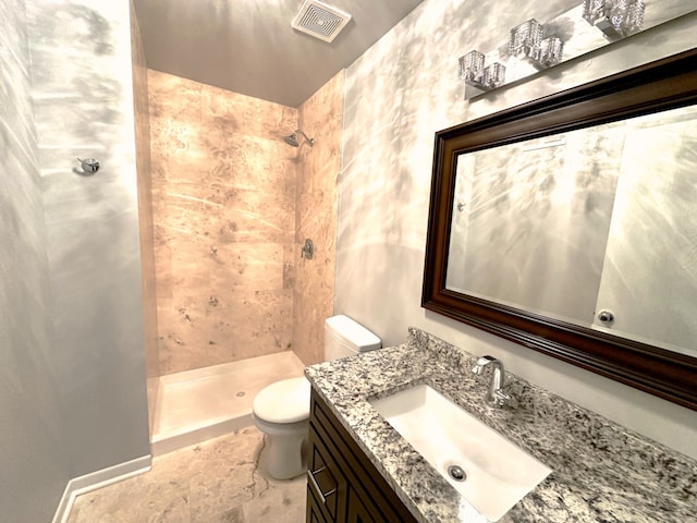 full bath with visible vents, toilet, vanity, and a tile shower