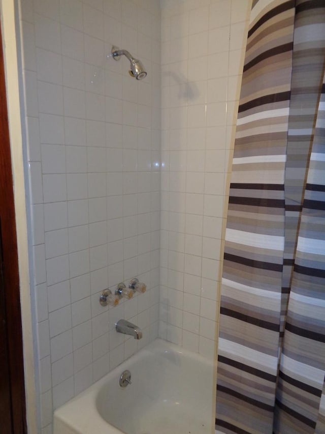 bathroom with shower / bath combination with curtain