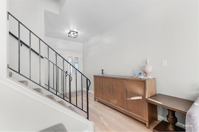 stairway featuring baseboards and wood finished floors