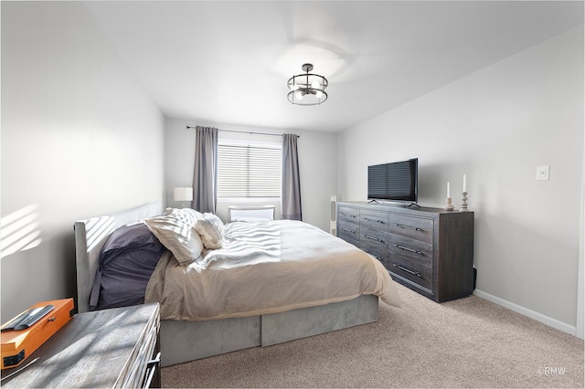 carpeted bedroom featuring baseboards