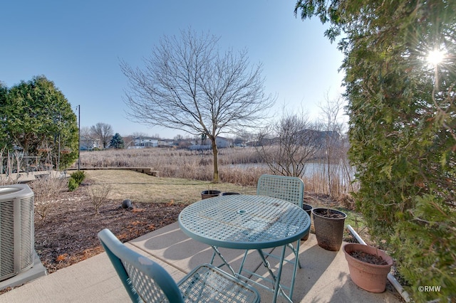 view of patio featuring cooling unit and outdoor dining space