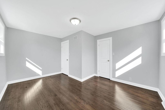 interior space with visible vents, wood finished floors, and baseboards