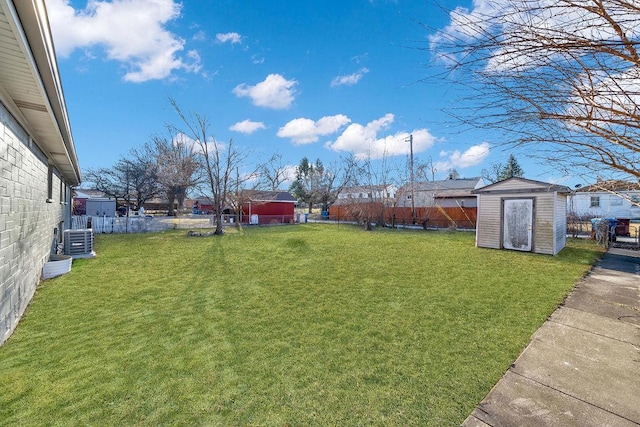 view of yard featuring central AC unit, an outdoor structure, a storage shed, and a fenced backyard