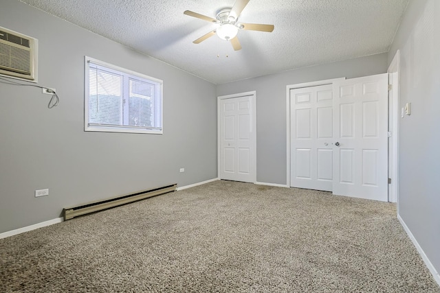 unfurnished bedroom with a textured ceiling, multiple closets, baseboard heating, and carpet floors