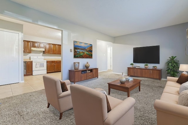 living room featuring baseboards, light colored carpet, and light tile patterned flooring