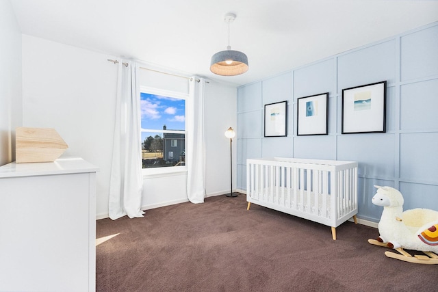 unfurnished bedroom with carpet floors and a nursery area