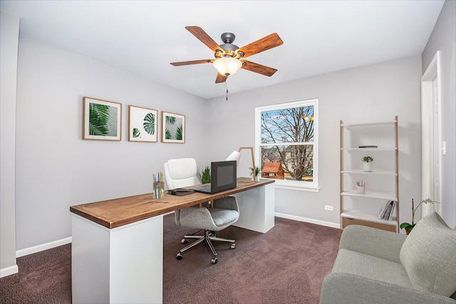 office featuring baseboards, ceiling fan, and dark carpet