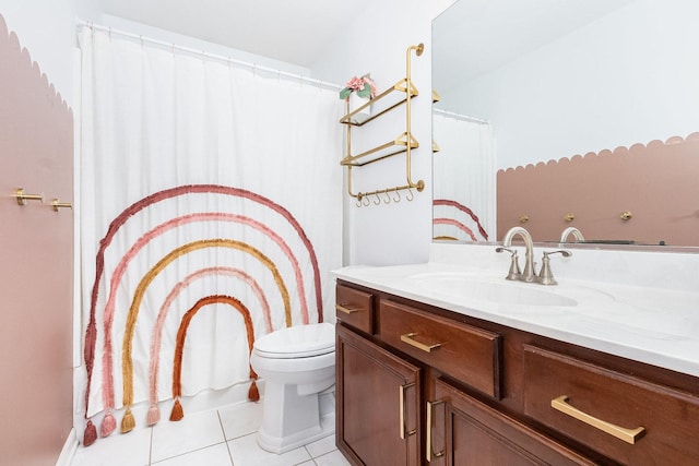 bathroom featuring vanity, tile patterned floors, and toilet