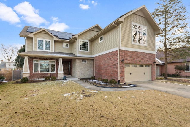 view of front of property with fence, driveway, a garage, brick siding, and roof mounted solar panels