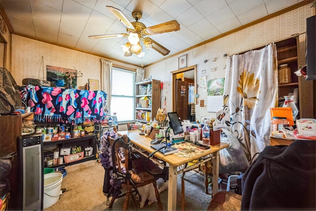 carpeted office with wallpapered walls, a ceiling fan, and ornamental molding