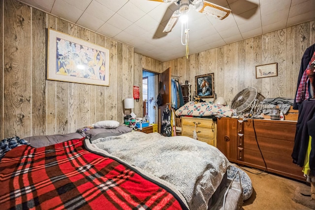 bedroom with wood walls and carpet flooring