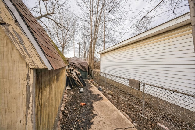 view of side of property featuring fence