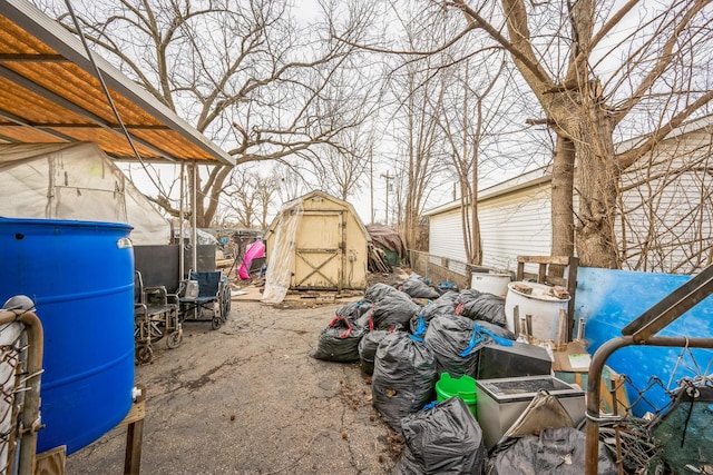 view of patio with an outbuilding and a storage unit