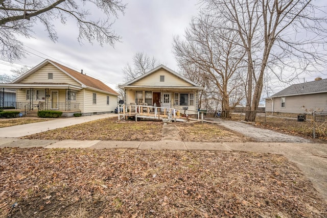 bungalow-style home featuring fence and covered porch