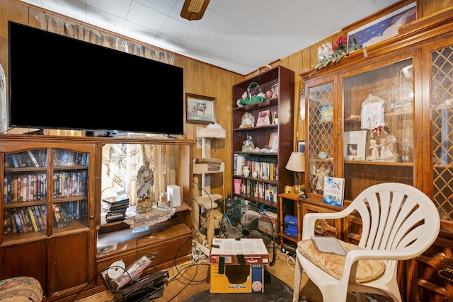 sitting room featuring wooden walls