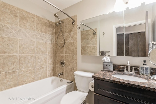 bathroom featuring shower / washtub combination, toilet, and vanity