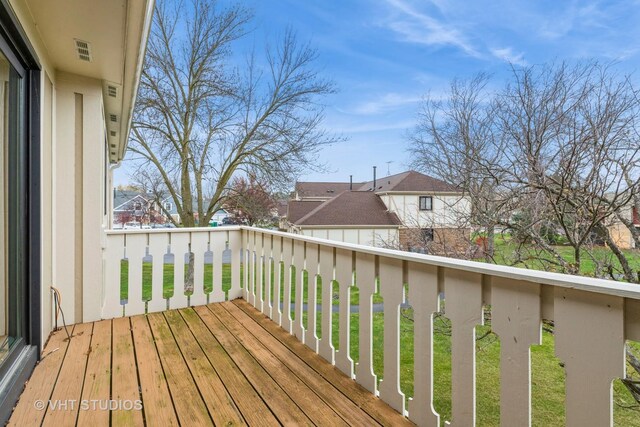 wooden deck with visible vents and a residential view