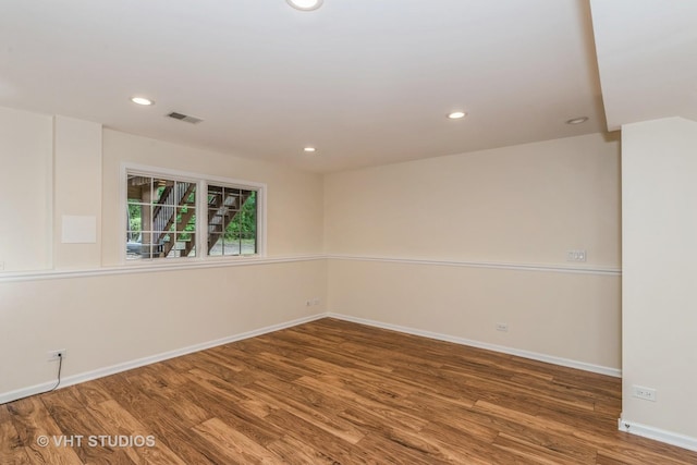 unfurnished room with recessed lighting, visible vents, baseboards, and wood finished floors