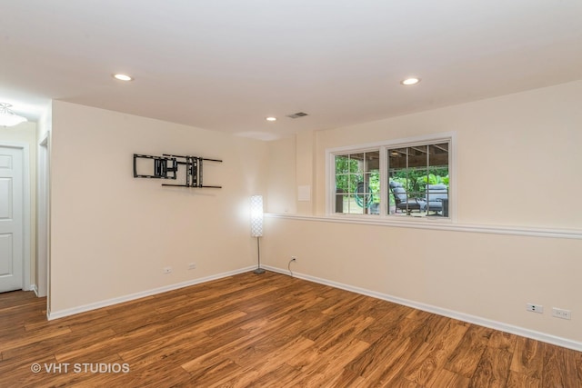 spare room featuring recessed lighting, wood finished floors, visible vents, and baseboards