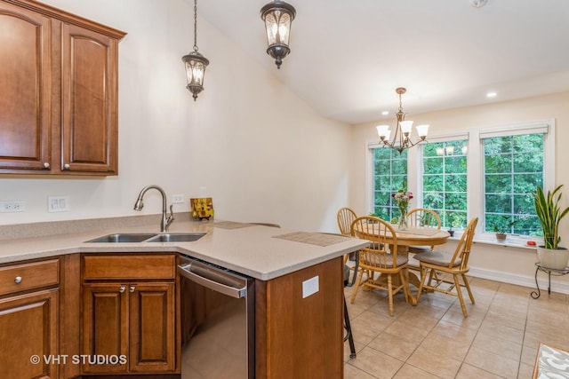 kitchen with brown cabinets, a sink, light countertops, dishwasher, and hanging light fixtures