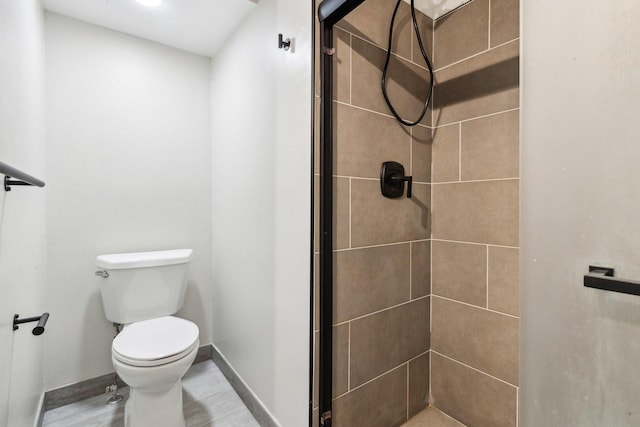 full bath with a shower stall, toilet, and baseboards