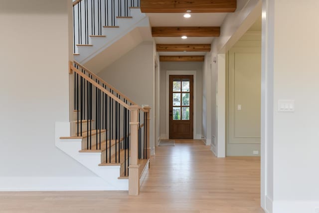 foyer entrance with stairway, baseboards, light wood-style flooring, recessed lighting, and beamed ceiling