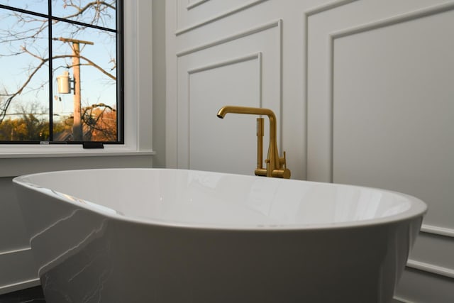 details with a sink and a freestanding bath